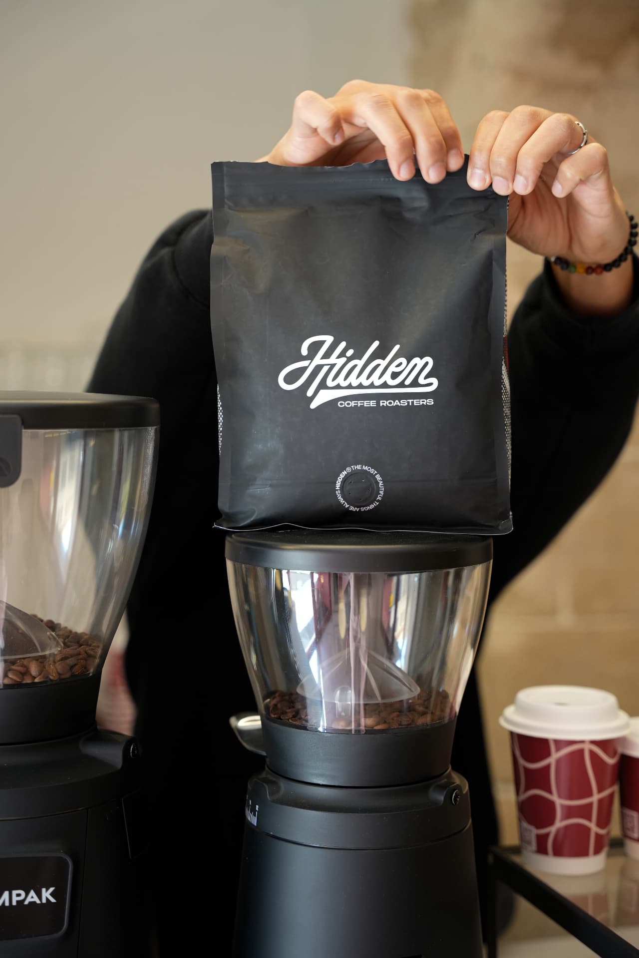 Bolsa de café de Hidden Coffee Roasters sobre el molino
